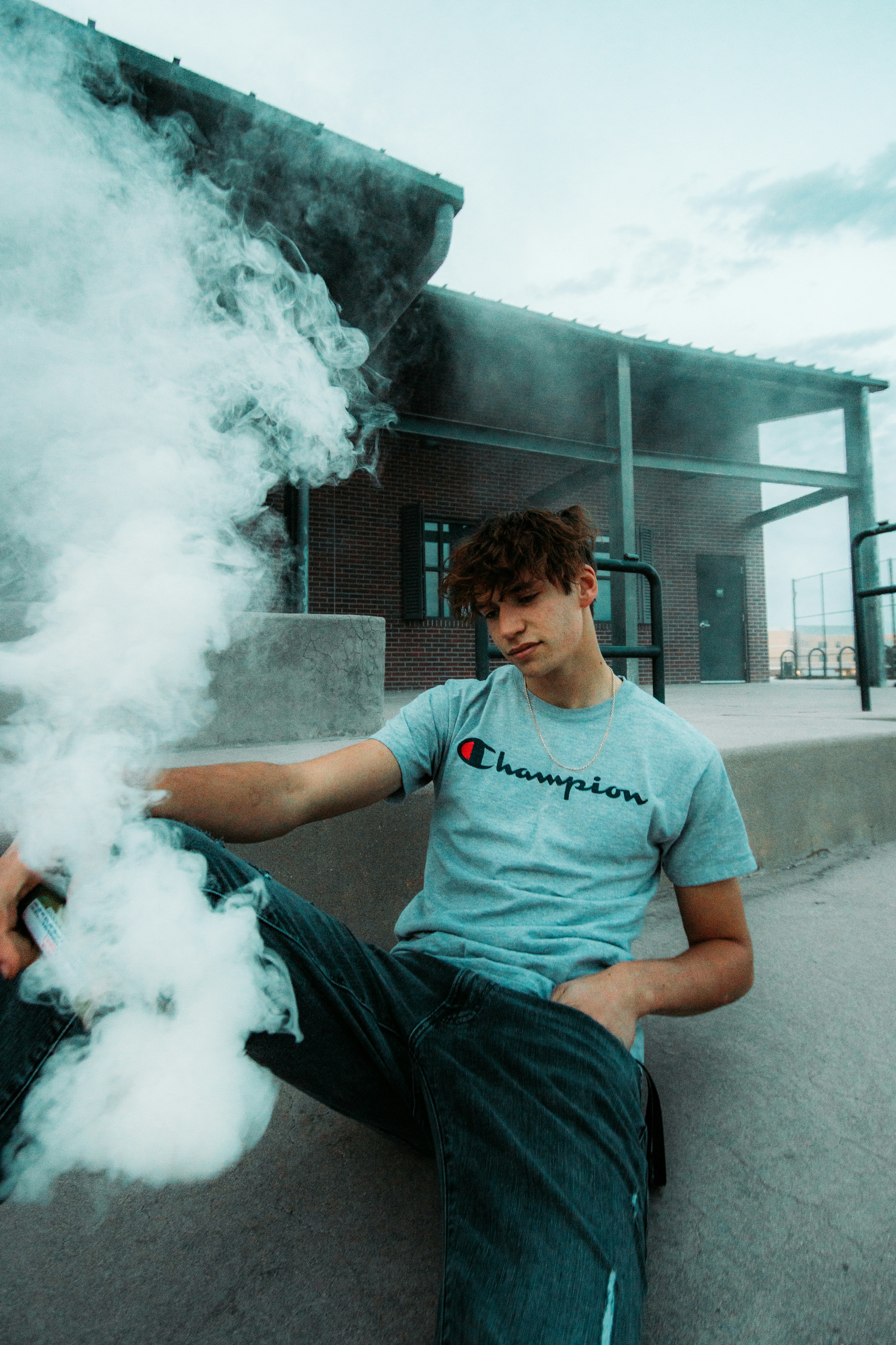 man in blue crew neck t-shirt smoking