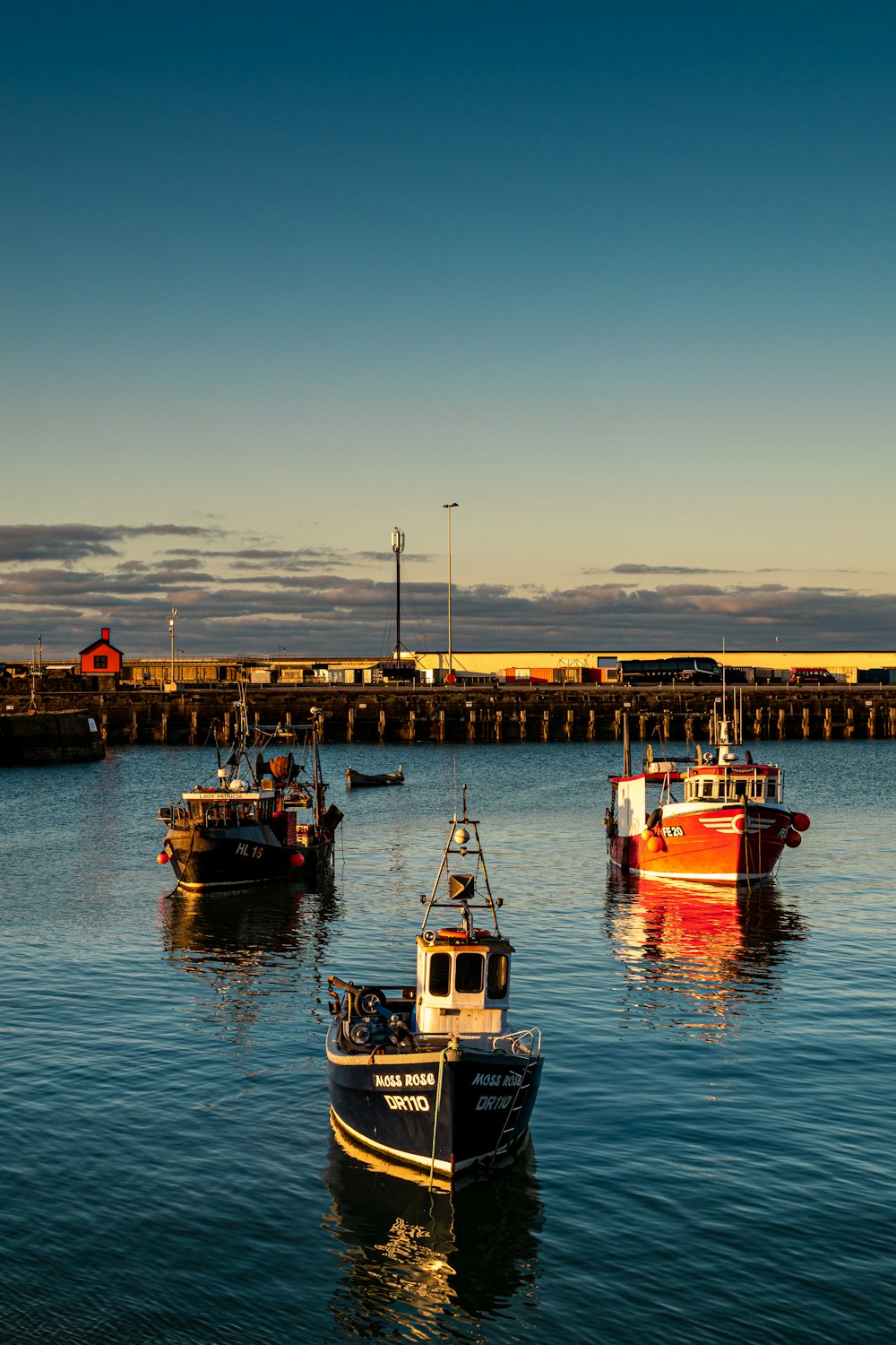 Royalty-Free photo: Red Blue and White Fishing Boats on Dock during Daytime