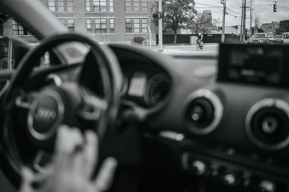 black steering wheel in grayscale photography