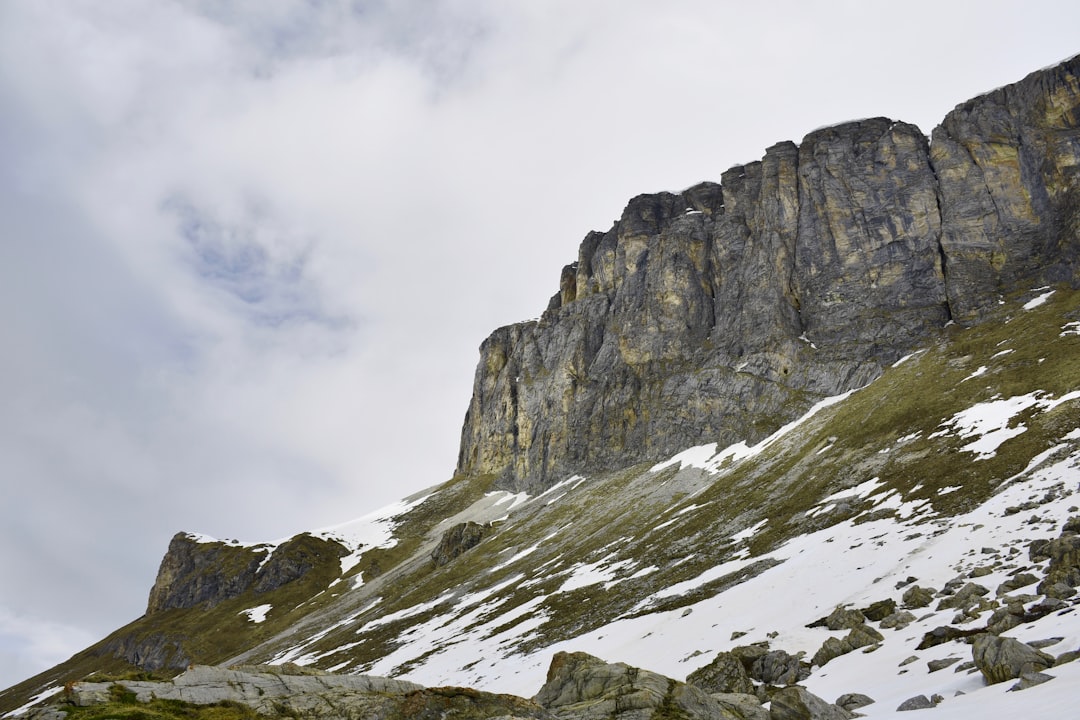 gray rocky mountain under white cloudy sky during daytime