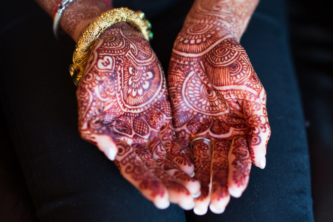 red and white floral pants, The henna tattooed hands of an Indian bride before her wedding.