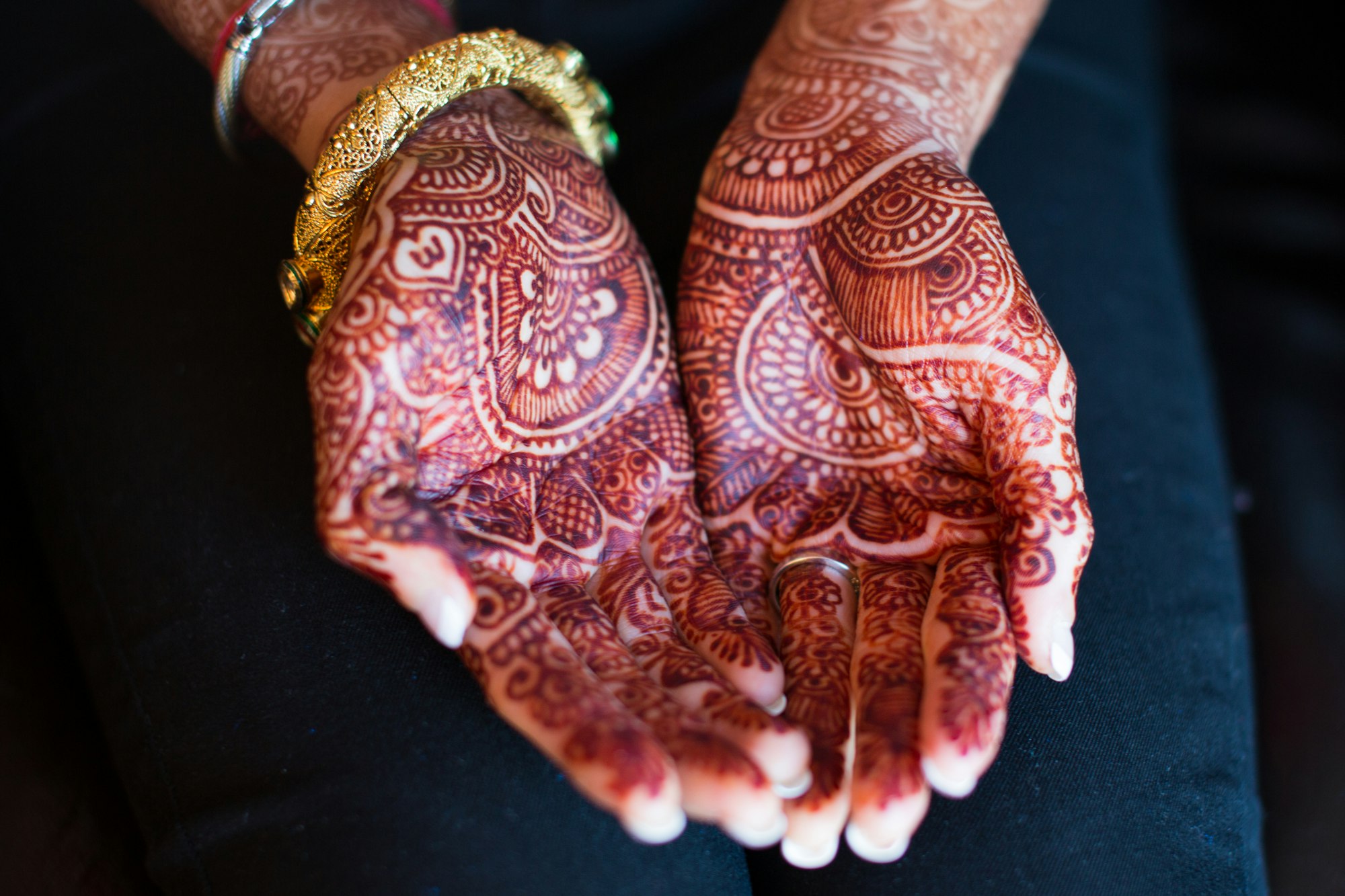 The henna tattooed  hands of an Indian bride before her wedding.