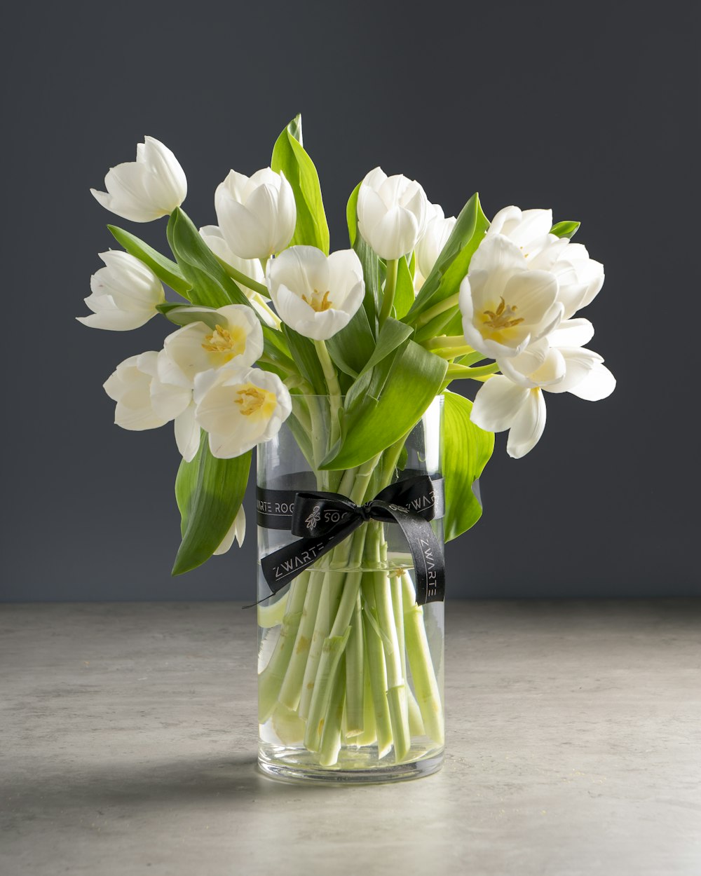 white flowers in clear glass vase