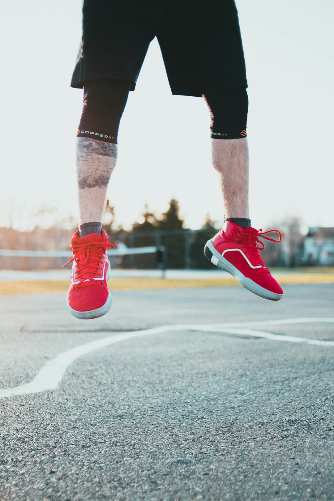 person in red nike sneakers