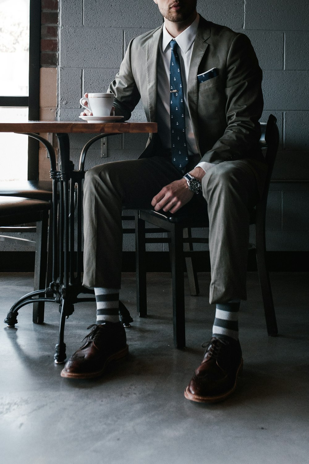 man in black suit sitting on chair