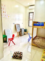 Children laughing and playing with educational toys in a bright room