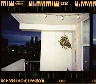 A cozy New York apartment balcony with city skyline at sunset.