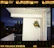 Modern balcony with sleek glass enclosure overlooking a city skyline at sunset.