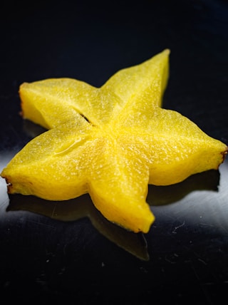 yellow star ornament on black surface