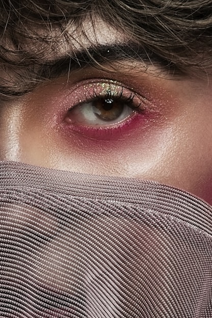 woman covering her face with gray textile