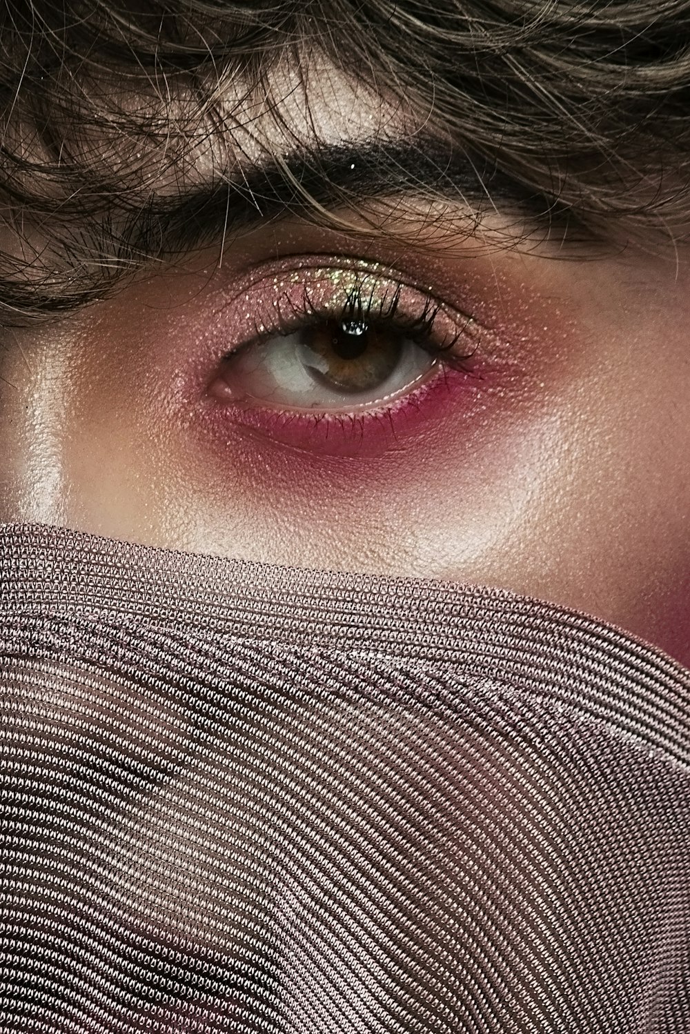 woman covering her face with gray textile