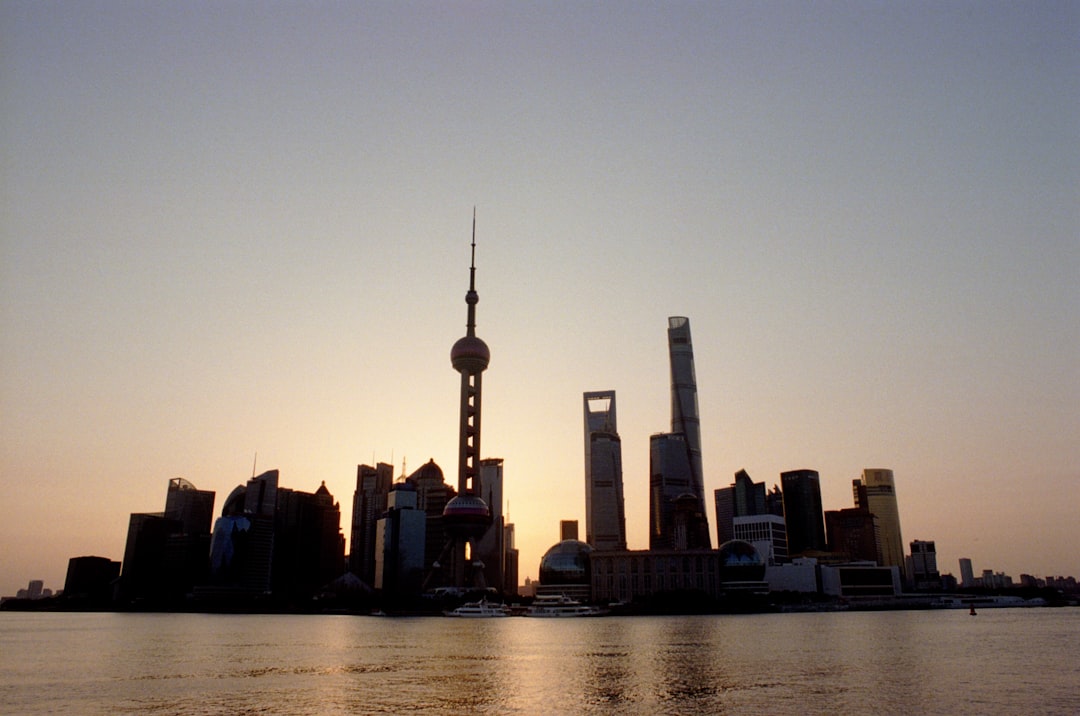 Sunrise at the Bund in Shanghai showing historic colonial architecture alongside modern Pudong skyline