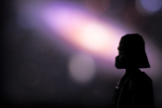 The silhouette of amtreonprediv x device emerging from shadows, radiating a mysterious energy.