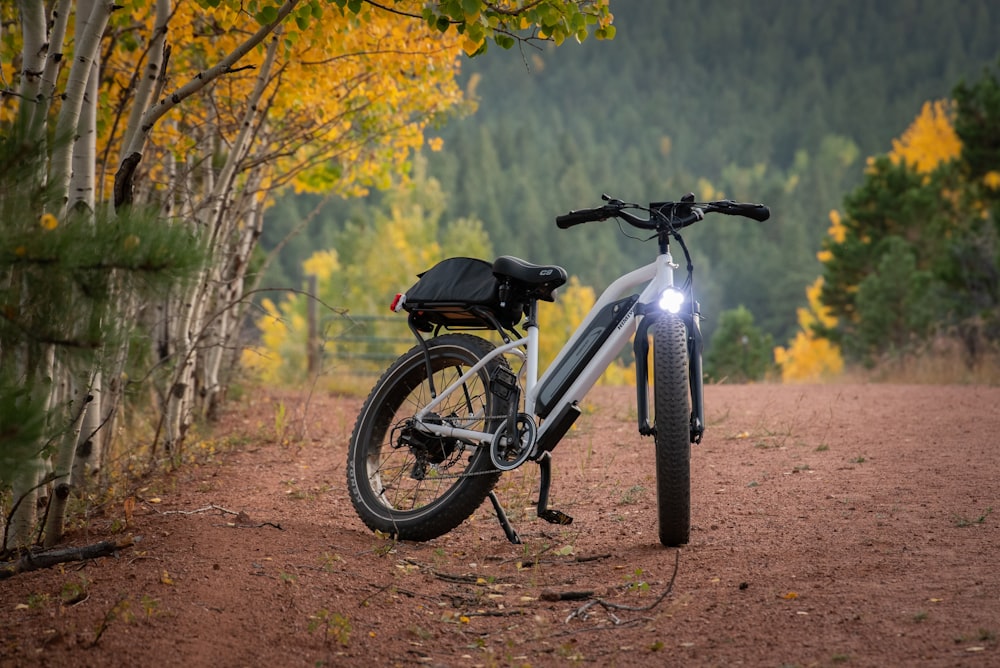 black and white mountain bike on dirt road during daytime