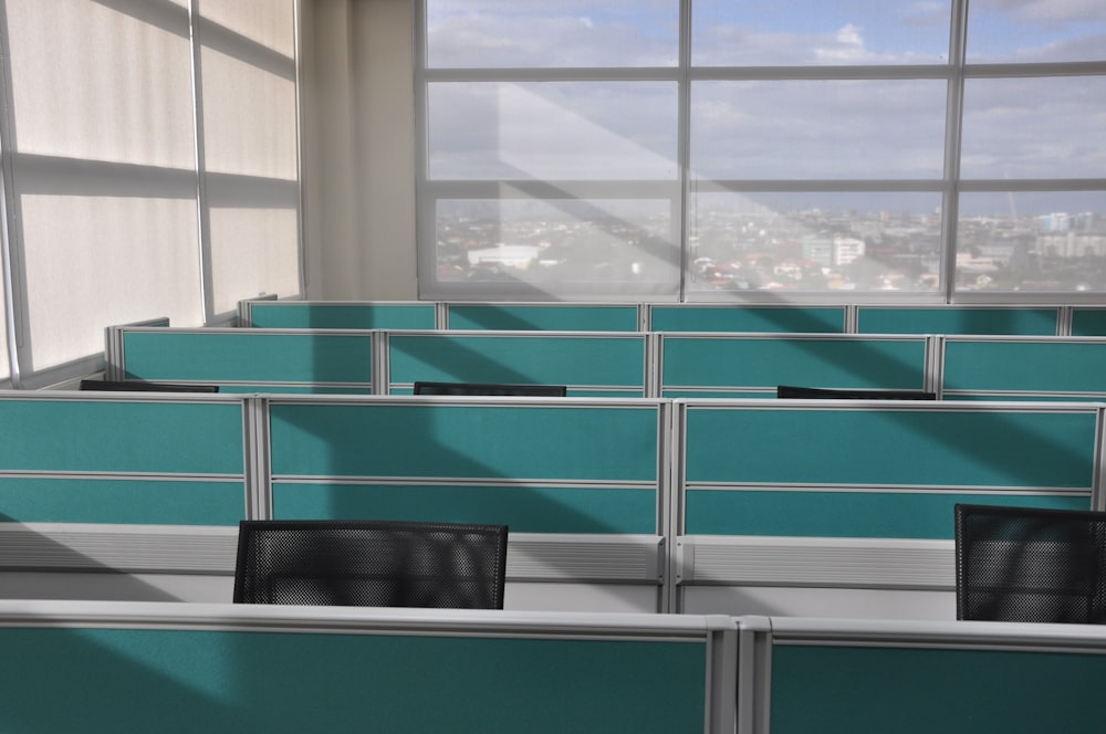 black leather chair beside glass window