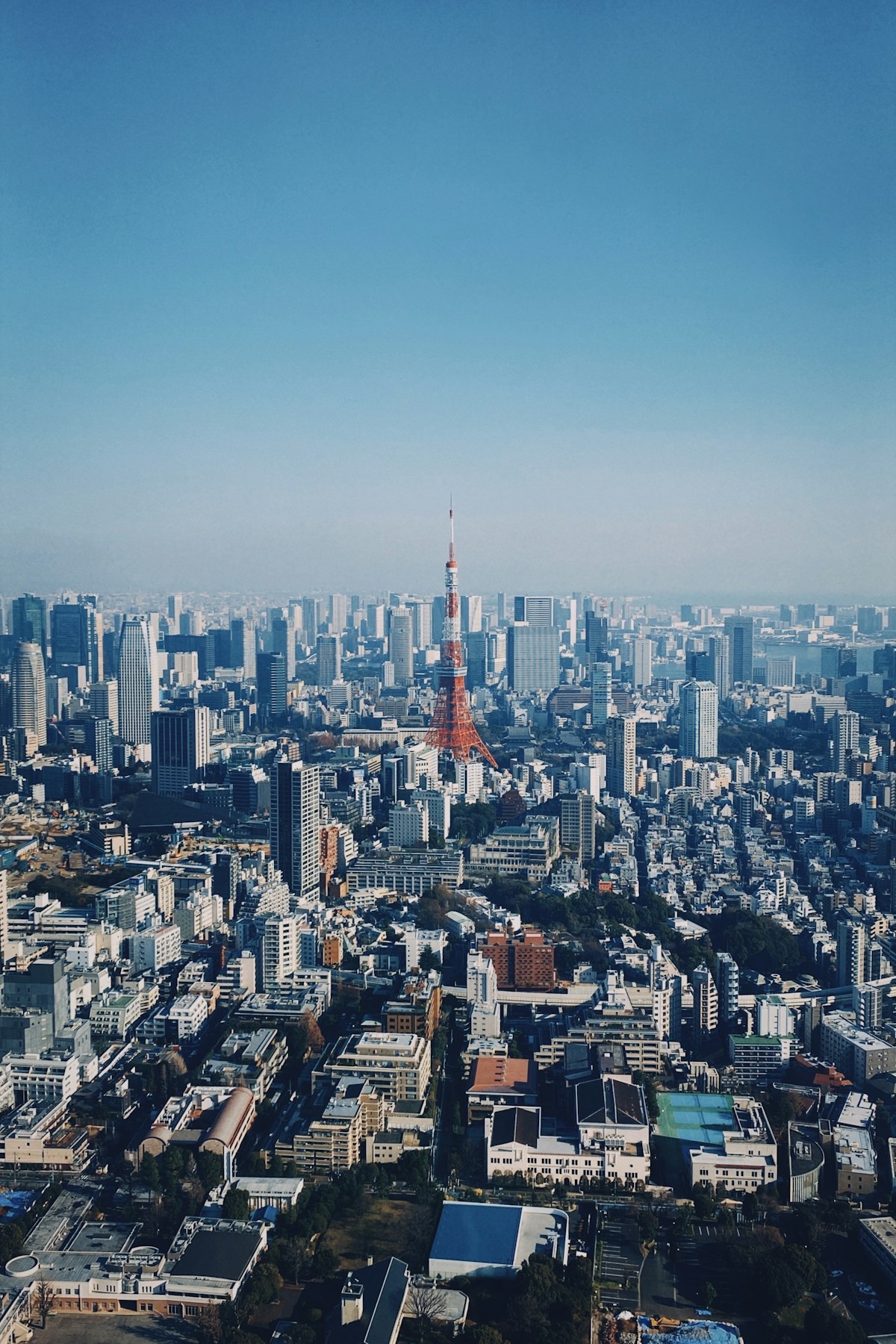 Aerial view of the Tokyo skyline with skyscrapers and urban sprawl stretching to the horizon