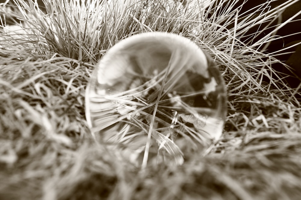 clear glass ball on white textile