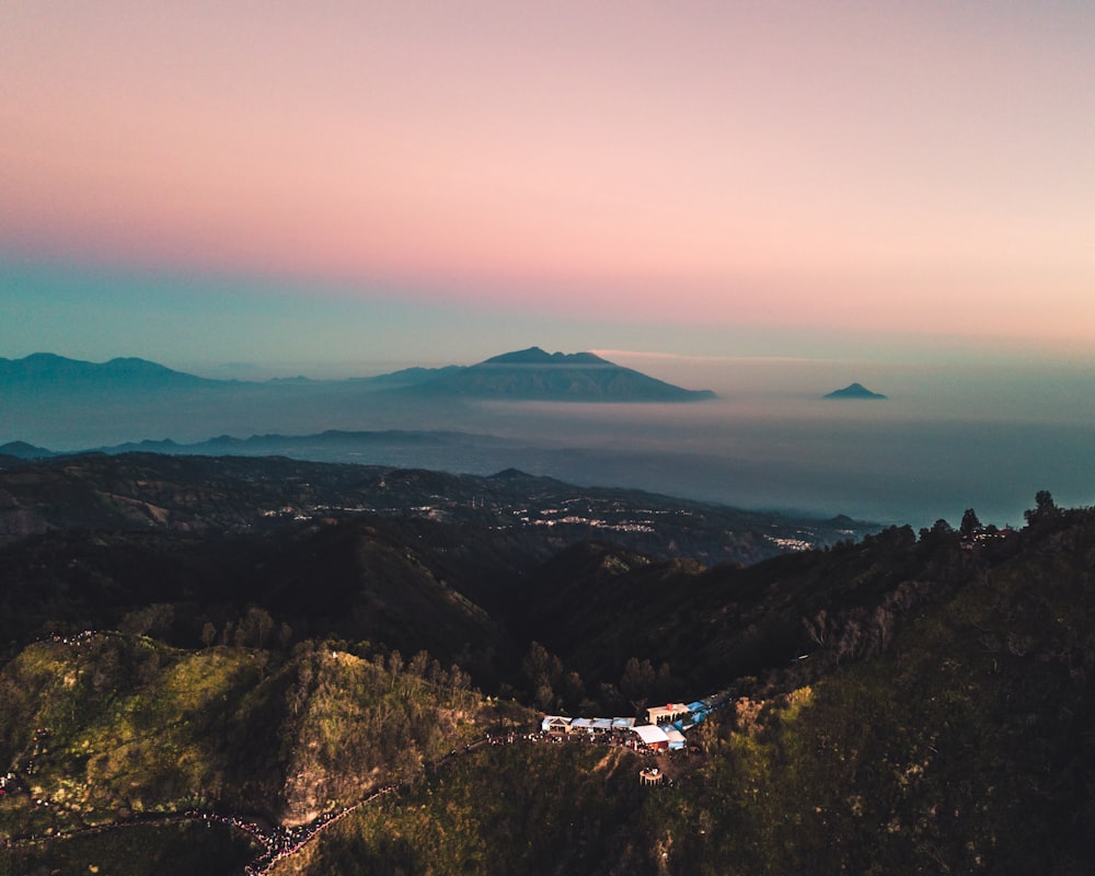 aerial view of green mountains during sunset