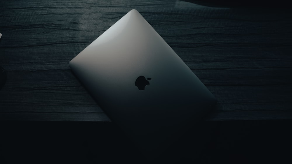 a laptop computer sitting on top of a wooden desk