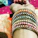 Close-up of colorful glass bangles stacked on a wrist with soft natural lighting