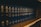 A row of dark blue hardcover books arranged on a wooden shelf, with uniform lettering on their spines indicating they are volumes of the General Laws of Massachusetts. The books appear to be reference materials organized in a comprehensive collection.