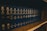 A row of dark blue hardcover books arranged on a wooden shelf, with uniform lettering on their spines indicating they are volumes of the General Laws of Massachusetts. The books appear to be reference materials organized in a comprehensive collection.