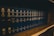 A row of dark blue hardcover books arranged on a wooden shelf, with uniform lettering on their spines indicating they are volumes of the General Laws of Massachusetts. The books appear to be reference materials organized in a comprehensive collection.