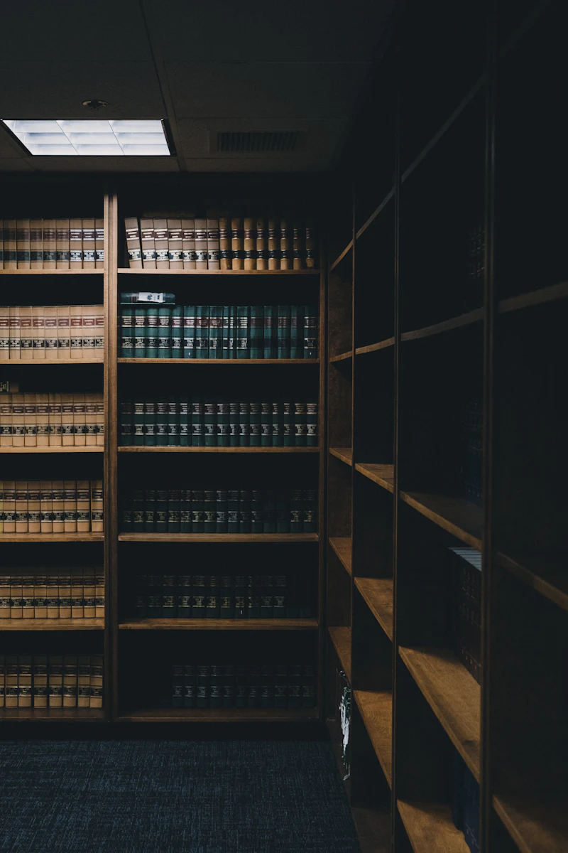 A quiet law library with tall shelves of legal texts and soft reading light
