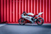 black and white sports bike parked beside red wall