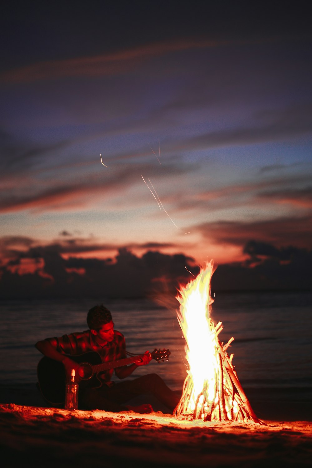 man in red jacket holding fire