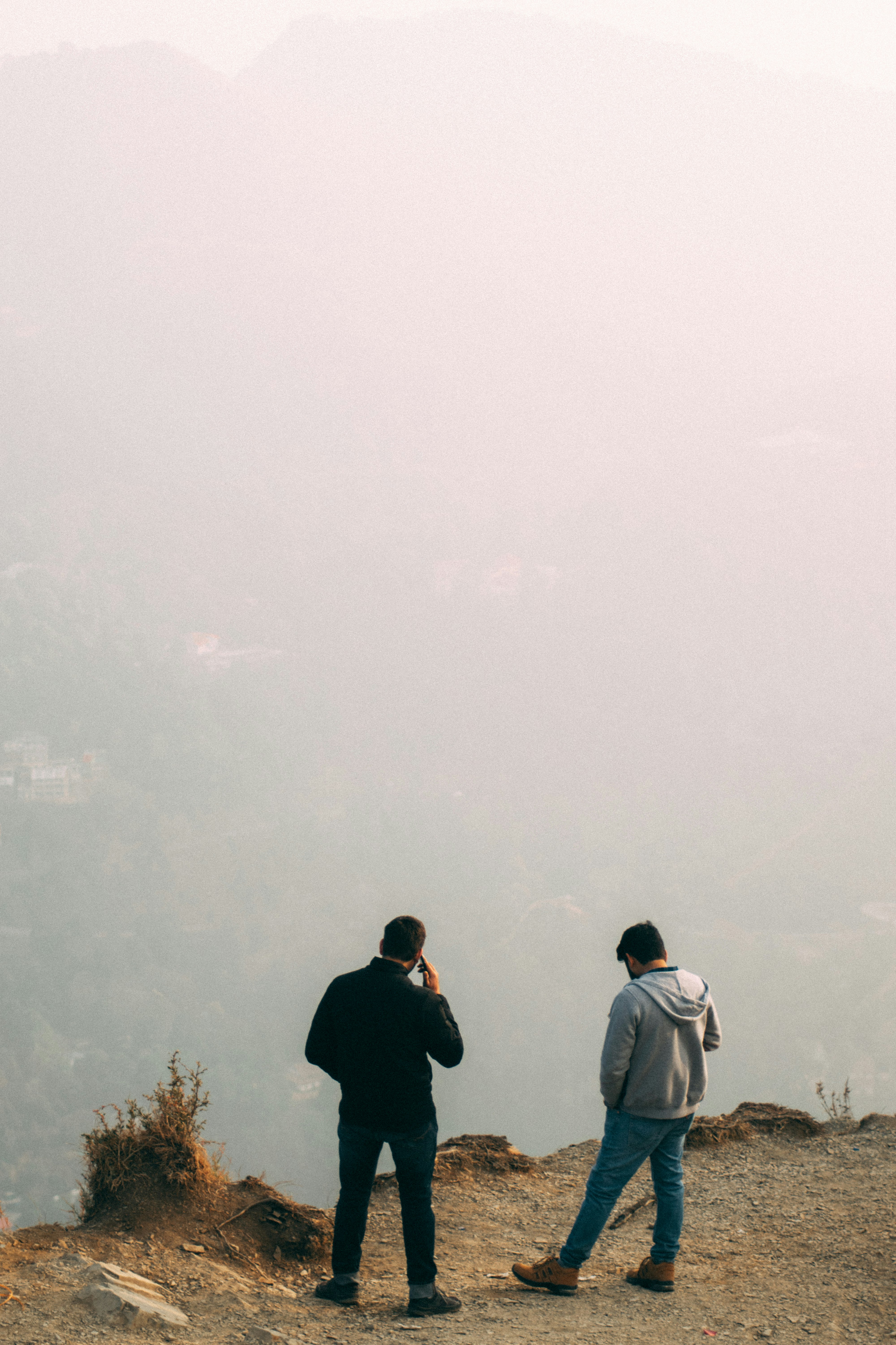 man in black jacket standing beside woman in white coat