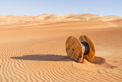 brown wooden round frame on brown sand strange teams background