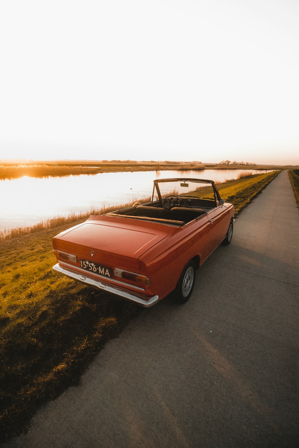 red chevrolet camaro on road during daytime