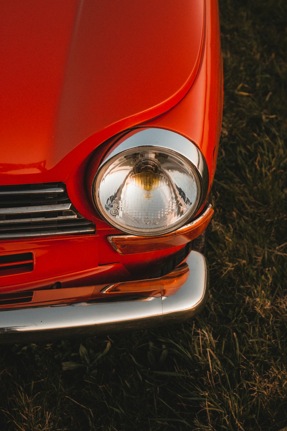 red car on brown grass