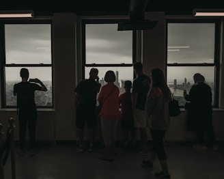 A business team reviewing strategy charts with a city skyline visible through the window.