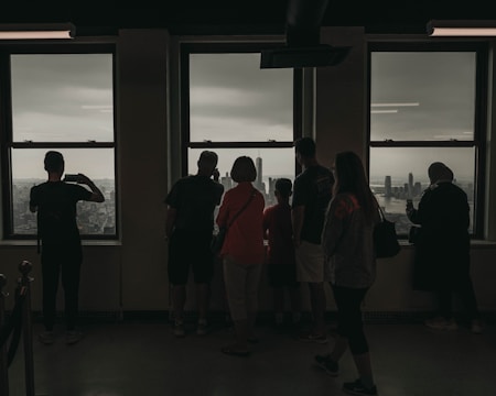 A business team reviewing strategy charts with a city skyline visible through the window.