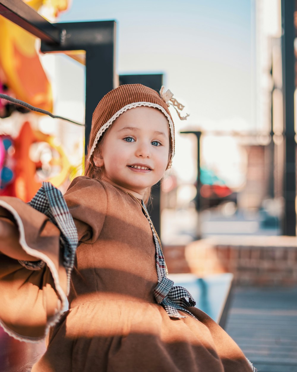 woman in brown and black stripe long sleeve shirt and blue and white knit cap sitting