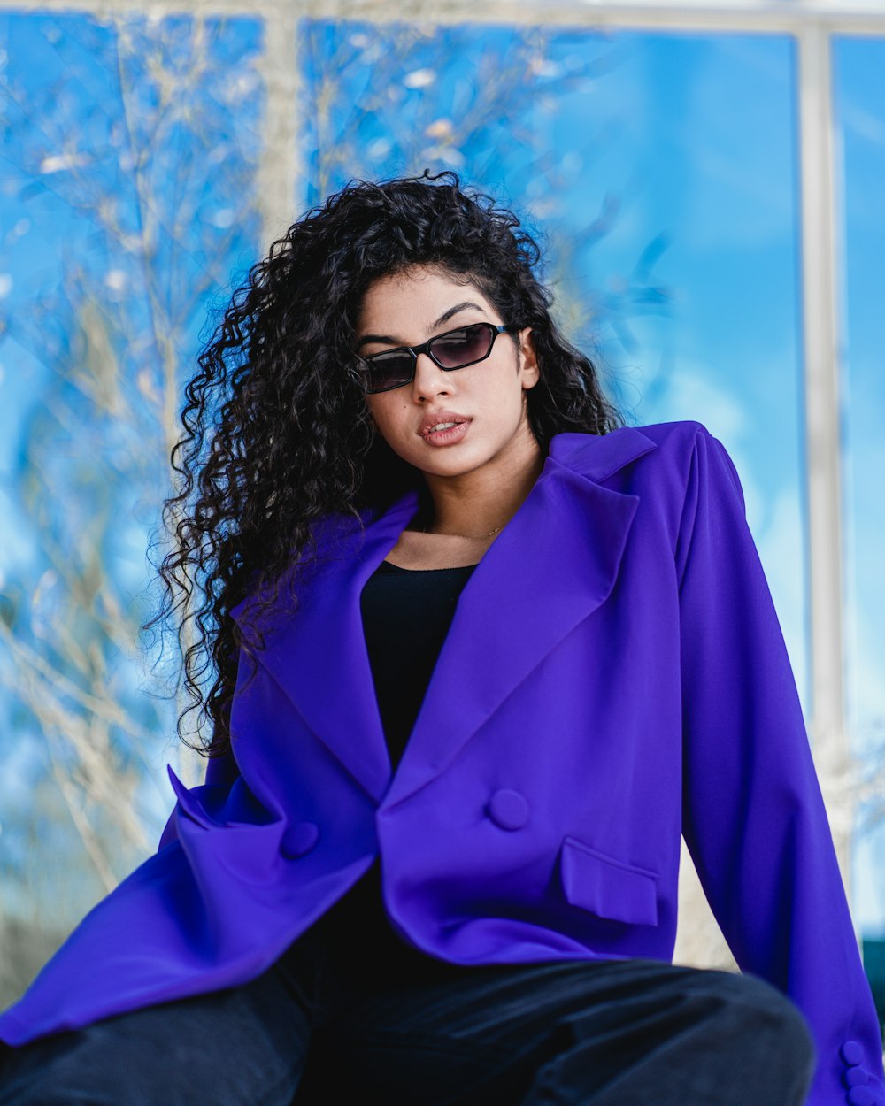 woman in blue blazer and black framed sunglasses
