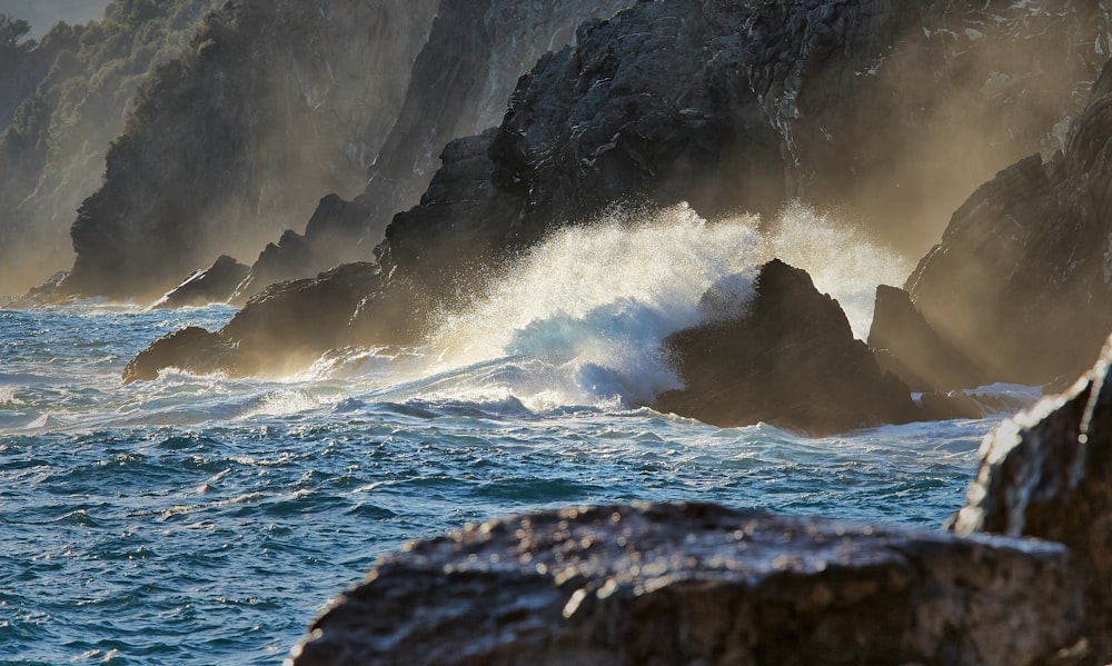 ocean waves crashing on rocky shore during daytime