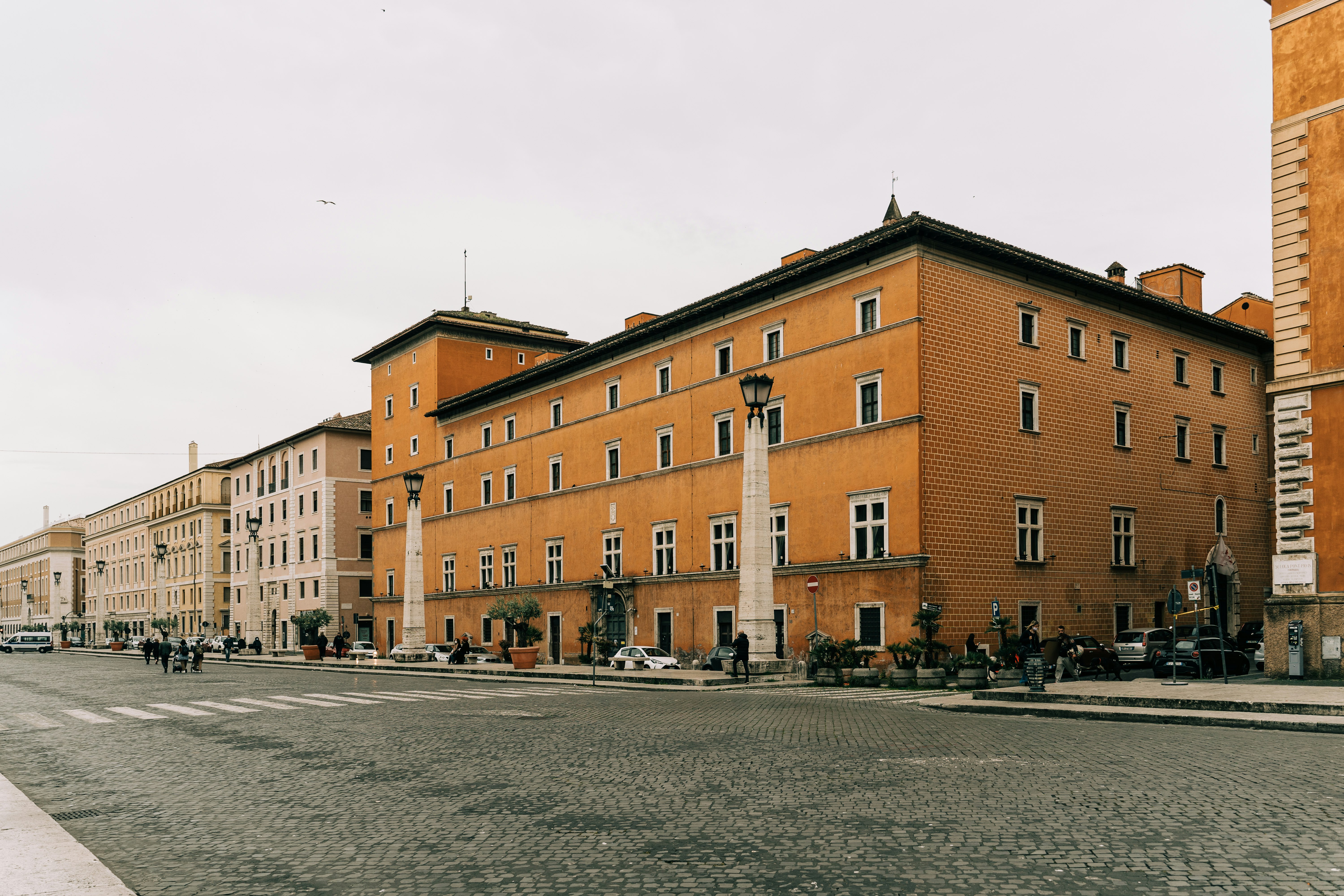 people walking on street near brown concrete building during daytime