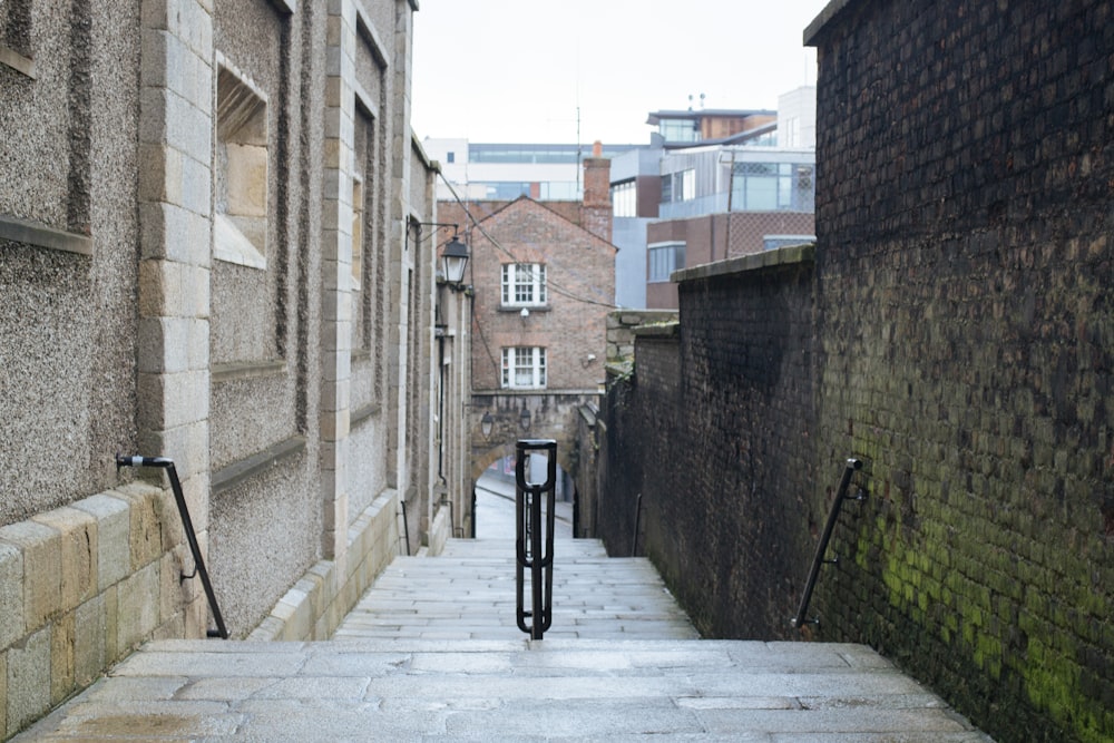 black bicycle parked beside brown concrete building during daytime