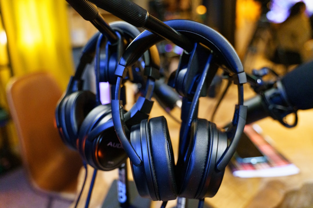 black headphones on brown wooden table,