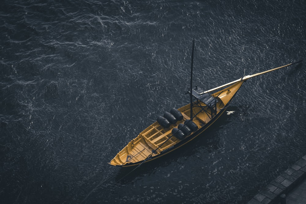 brown and black boat on body of water