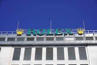 a sign that says rolex on top of a building