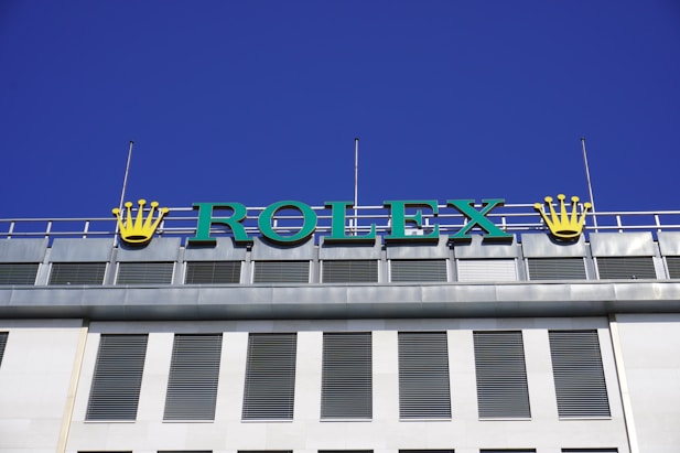 a sign that says rolex on top of a building