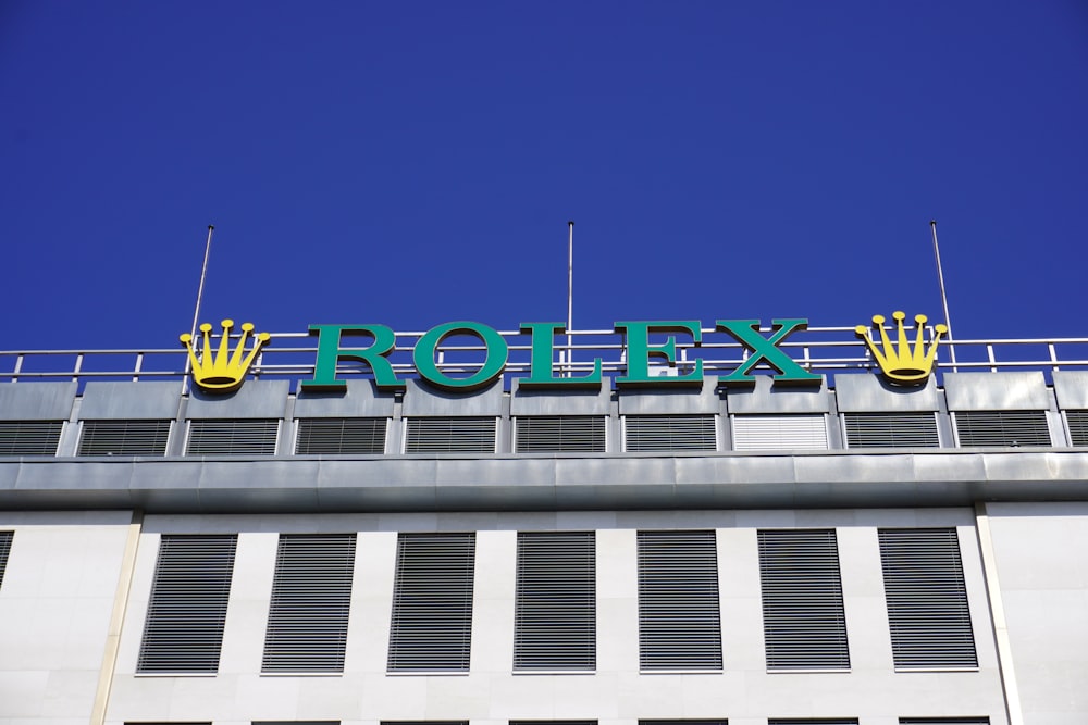 a sign that says rolex on top of a building
