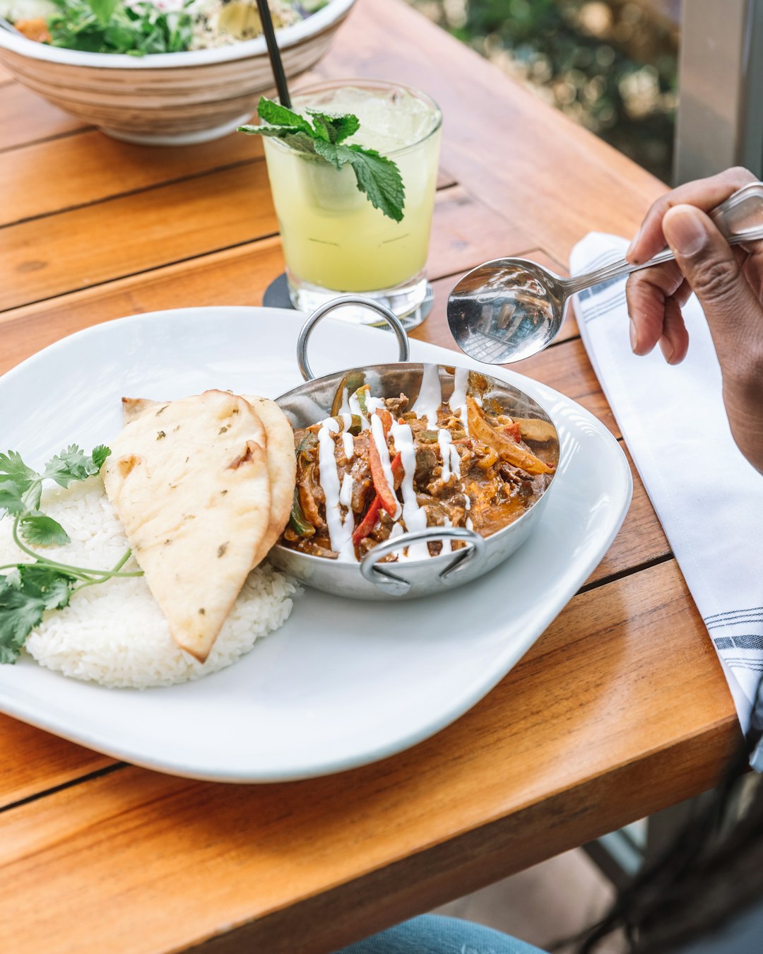 person holding stainless steel spoon and fork