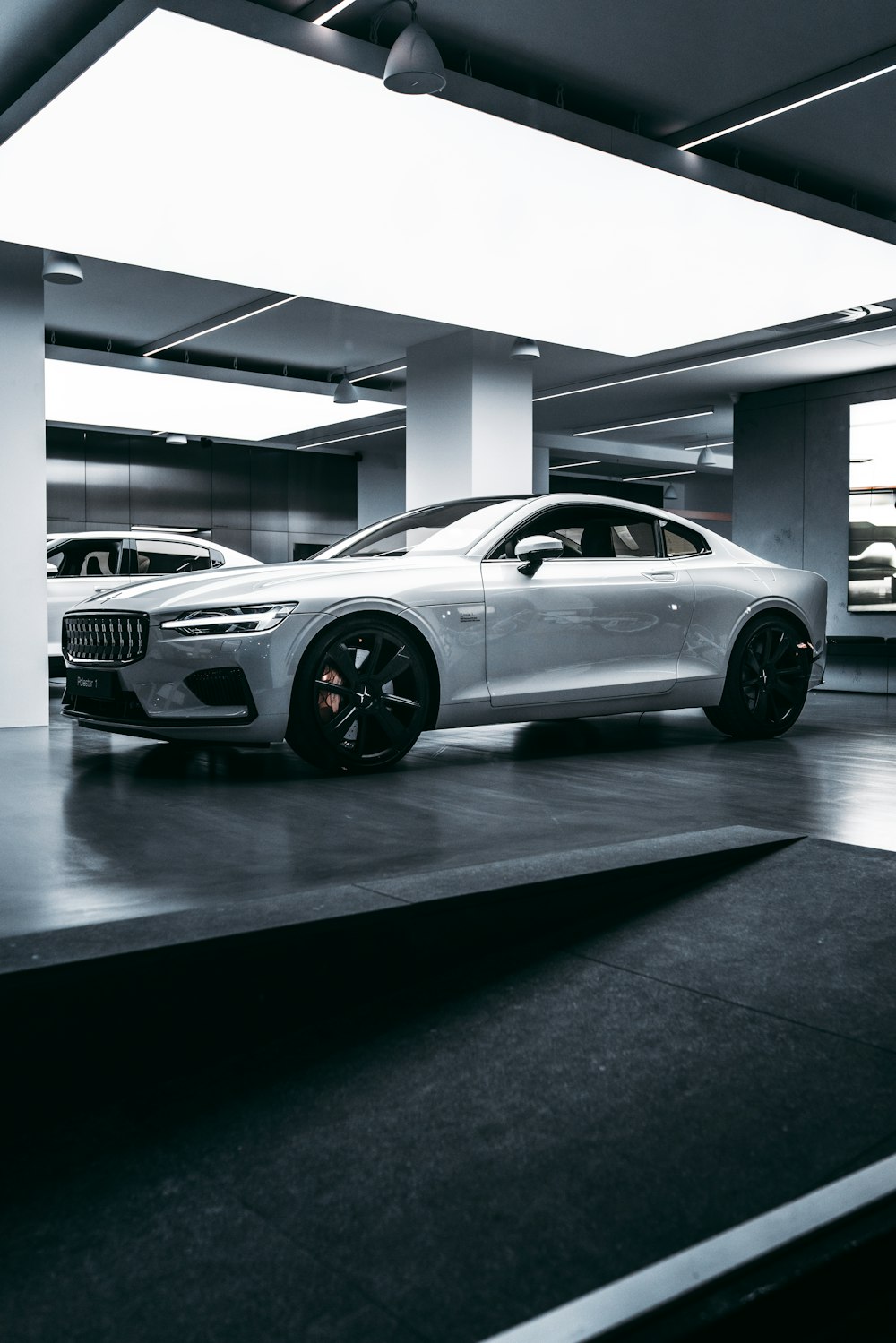 silver bmw m 3 coupe parked in building