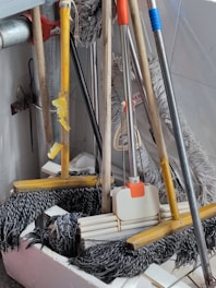 Professional-grade cleaning gear including gloves, mops, and disinfectants in a tidy storage area.
