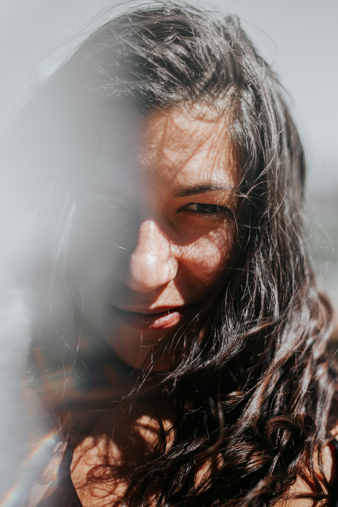 woman with black hair smiling